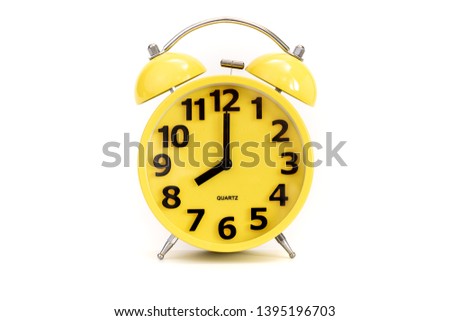 Yellow alarm clock on white at 8 o'clock
