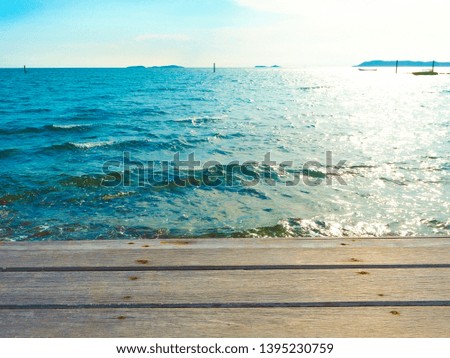 brown wood on the seaside and soft ocean wave to rocks with Summer,Holiday,Vacation and Travel concept