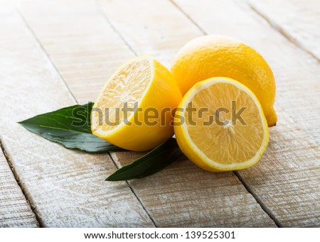 Fresh lemons on wooden background. Selective focus. Royalty-Free Stock Photo #139525301