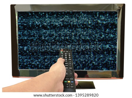 hand holding television remote control pointing to glitch on screen background