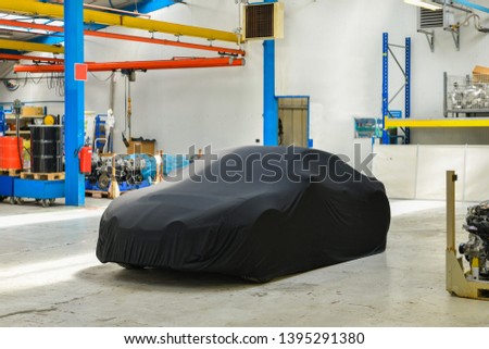 New covered car model at the factory before the presentation