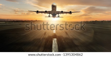 Huge two storeys commercial jetliner taking off. Modern and fastest mode of transportation. Dramatic sunset sky on background Royalty-Free Stock Photo #1395304862