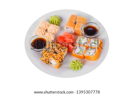 Set of sushi, rolls, uramaki, hosomaki california and philadelphia, lava sauce, marinated ginger and wasabi, white isolated background, side view