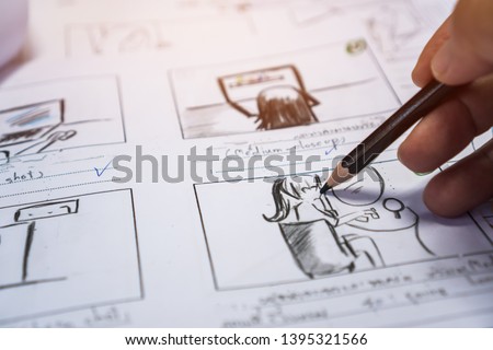 Hands on Storyboard movie layout for pre-production, storytelling drawing creative for process production media films. Script video editors and writing graphic in form displayed in maker shooting