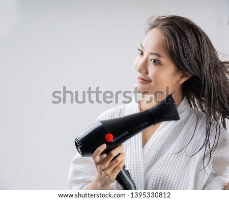 Asian woman drying your hair after showering Royalty-Free Stock Photo #1395330812