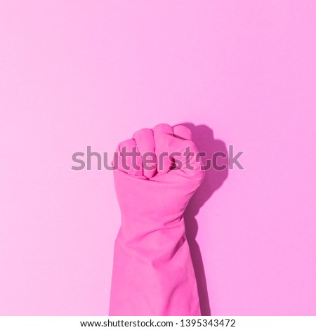 Fashion creative concept with hand in pink rubber glove, showing gesture. Symbol of super power. Aesthetic abstract minimalism. 