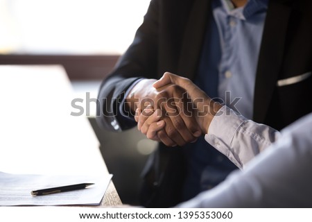 Close up african american businessman shaking hands with caucasian client. Handshake is symbol of starting finishing negotiations, successful teamwork signing contract, hiring human resource concept Royalty-Free Stock Photo #1395353060