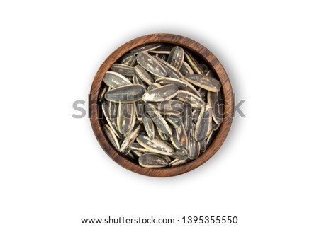 top view (Flat lat) of Sunflower seeds in wooden bowl isolated on white background view with Clipping path.