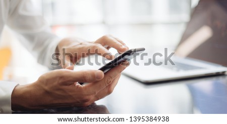 Man pointing on smartphone screen, chatting in social networks, meeting website, searching internet, sending sms, using text messenger or online banking. Close up of male hands