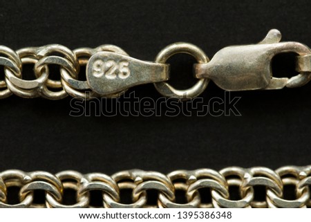 silver necklace of test 925 on a black background. close up  Royalty-Free Stock Photo #1395386348