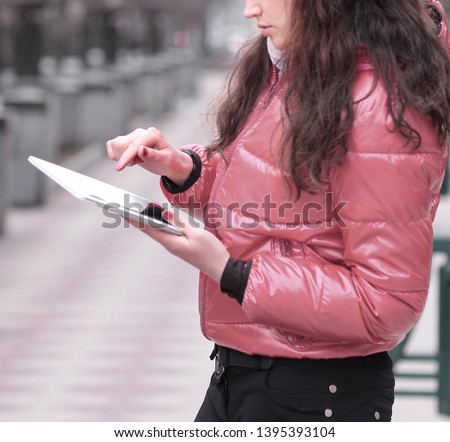 smiling woman looking at digital tablet screen