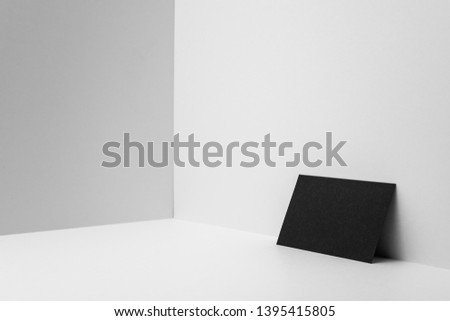 Design concept - perspective view of horizontal black business card on white 3D space background for mockup, it's real photo, not 3D render