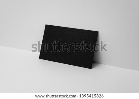 Design concept - perspective view of horizontal black business card on white 3D space background for mockup, it's real photo, not 3D render