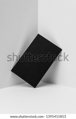 Design concept - perspective view of vertical black business card on white 3D space background for mockup, it's real photo, not 3D render