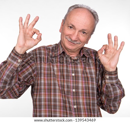 Elderly man shows ok sigh on a white background