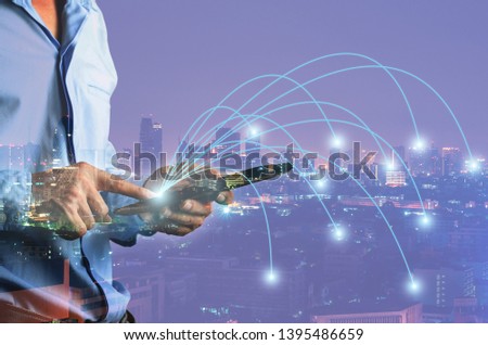 double exposure businessman use touch on mobile phone with night cityscape data link point to city with technology communication connecting global network online concept.