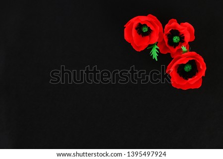 Diy paper red poppy Anzac Day, Remembrance, Remember, Memorial day made of crepe paper on black background. Symbol war. Gift idea, decor. Copy space. Top view.