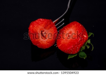 cut in two halves with a fork on black background dark