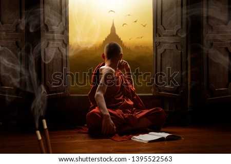Novice buddhist monk inside a temple in the Bagan Valley Royalty-Free Stock Photo #1395522563