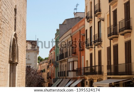Exterior view of historical buildings in the old town streets of Figueres, the province of Gerona, Catalonia, Spain, Europe. Facades of colorful houses, Spanish Mediterranean downtown neighborhood. Royalty-Free Stock Photo #1395524174