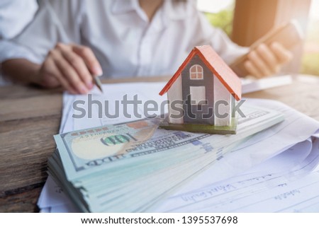 House model and money in hand, Concept of real estate and deal