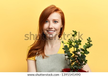 cute positive girl selling flowers. close up photo. job, profession, occupation concepts. business