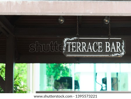 a sign hanging under a shed with the inscription Terrace Bar