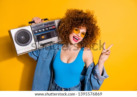 Close up photo beautiful she her lady wavy fluffy styling curls old-fashioned tape recorder show v-sign wear casual jeans denim shirt shorts tank top outfit clothes isolated yellow bright background
