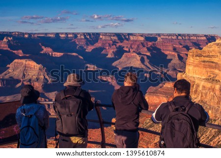 Group of people enjoying the view of Grand Canyon National park at mojave point during sunset hour