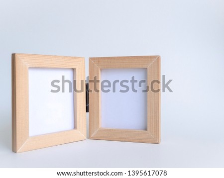 Twin blank wood picture fame with black hinge, Bi-fold wooden photo frame on white background with clipping path.
