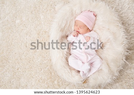 Sleeping New Born Baby, Newborn Kid Sleep on White Fur, Beautiful Infant Studio Portrait, One month old Royalty-Free Stock Photo #1395624623
