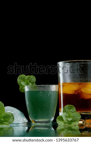 Alcoholic drinks with ice salt mint on red background