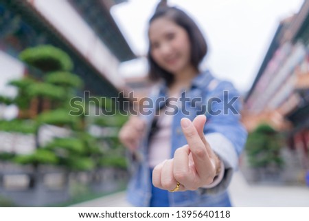 Asian girl hand in heart form love, close up.
Happy young woman hand in mini heart shape send a message to care. I love you.
February - valentine’s day, life style and happy time concept.