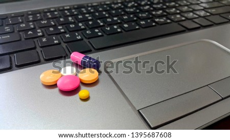 Pills and drugs on the laptop computer, health problems for office work Royalty-Free Stock Photo #1395687608