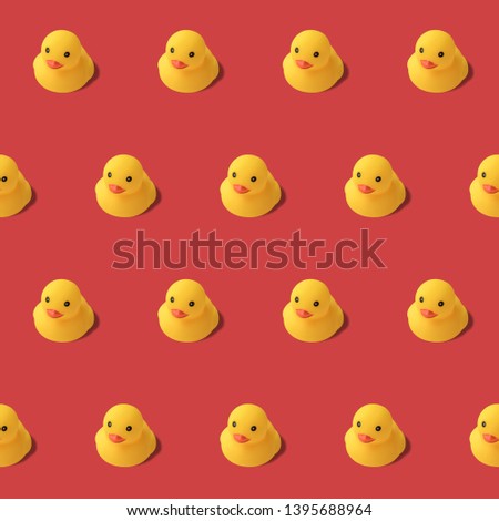 repeatable pattern of yellow rubber duck on red background Modern style. creative photography.