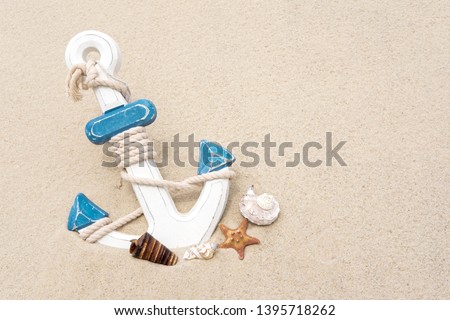 Nautical background with anchor. Anchor in the sand. Frame for a banner text from sand with an anchor and seashells