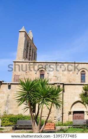 Vertical picture of beautiful Bellapais Abbey in Northern Cyprus taken on a sunny day. The ruins of the ancient monastery are popular tourist attraction.