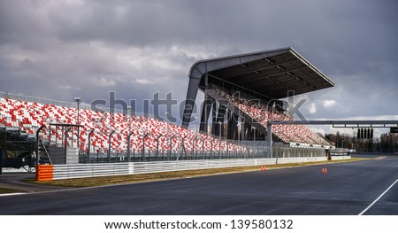 Giant tribune with colorized seats on track Royalty-Free Stock Photo #139580132