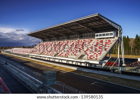 Giant tribune with colorized seats on track Royalty-Free Stock Photo #139580135