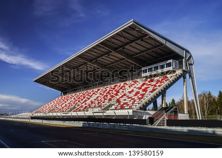 Giant tribune with colorized seats on Formula 1 track Royalty-Free Stock Photo #139580159