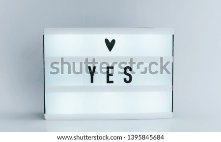 Photo of a light box with text, YES, isolated white background