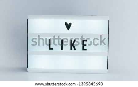 Photo of a light box with text, LIKE, isolated white background
