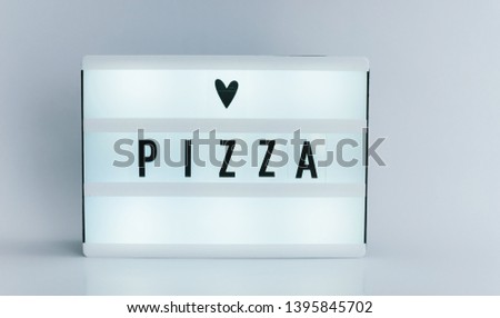 Photo of a light box with text, PIZZA, isolated white background