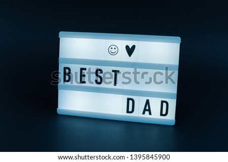 Photo of a light box with text, BEST DAD, over isolated dark background
