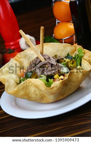 Taco Salad in a Tortilla Bowl with Beef meat and Lettuce