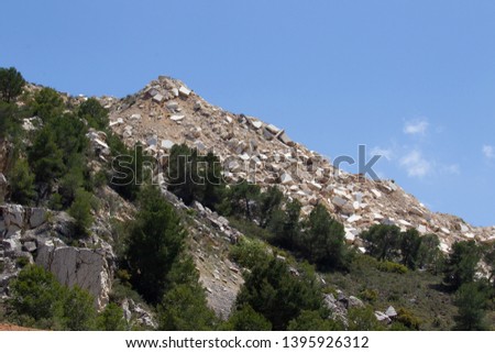 Remains of marble quarries under the blue sky.