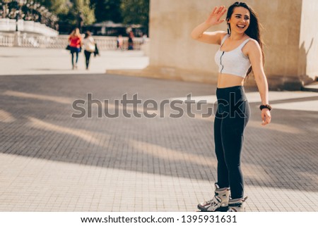 Roller skating sporty girl in park rollerblading on inline skates