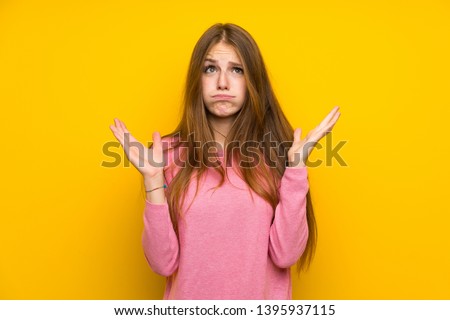 Young woman with long hair over isolated yellow wall frustrated by a bad situation Royalty-Free Stock Photo #1395937115