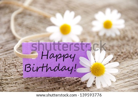 happy birthday written on a purple banner, flowery background