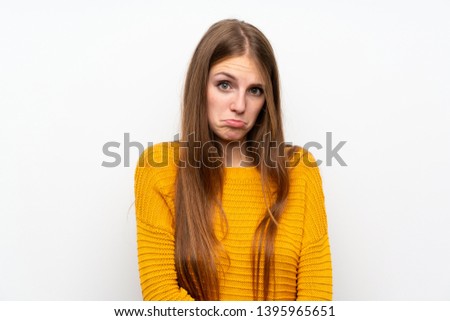 Young woman with yellow over isolated white wall sad